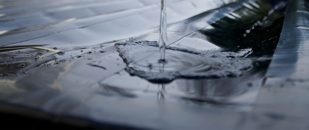 water running down black trough
