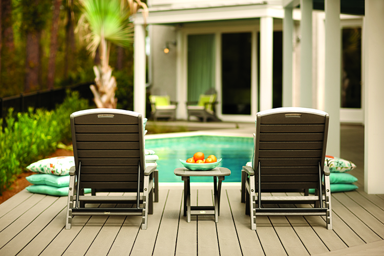 two chairs by a pool on a deck